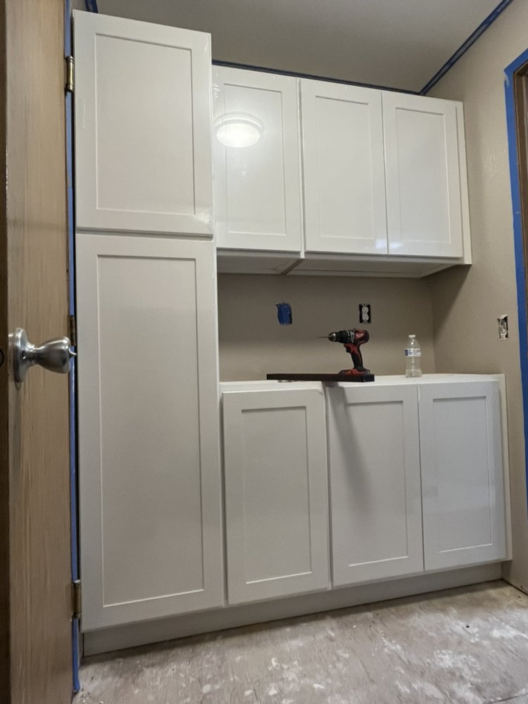 White shaker cabinet installation — laundry room