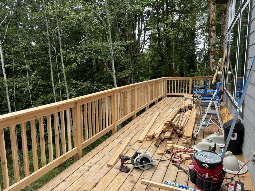 Elevated deck construction with cedar railings in wooded setting