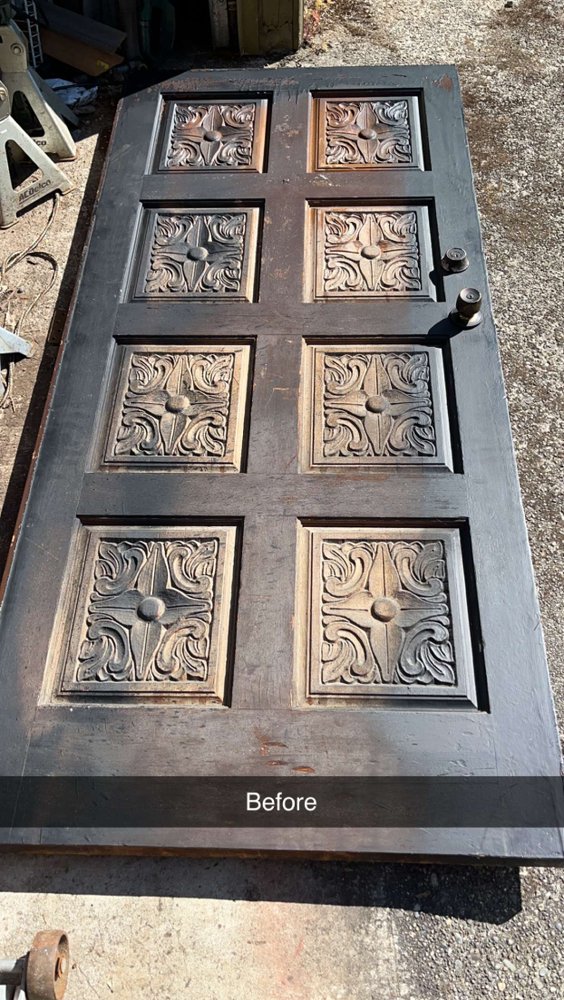 Ornate carved entry door before refinishing