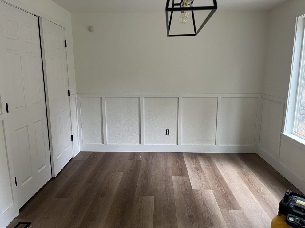Wainscoting and LVP flooring installation — clean finish carpentry